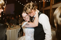A couple embracing on the dance floor at their wedding at the Fraser River Lodge