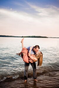 Groom dramatically kissing bride during their Waterfront Elopement at Long Hunter State Park