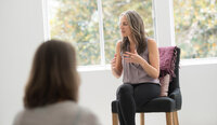 Marcia on a chair presenting Yoga of Stillness