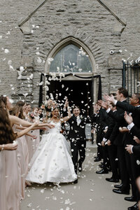 a bride and groom flower petal exit from a Catholic Church