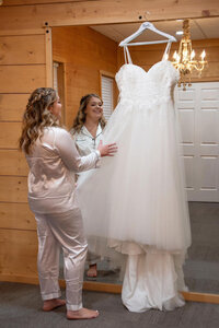 Bride holding her hanged wedding dress