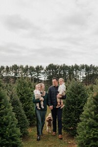 Family walking through tree farm in Cleveland during Christmas mini session
