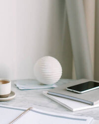 saas copywriter desk with phone and papers