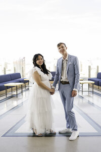 Newlyweds holding hands atop GhostBar at the Palms Casino.