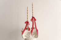 candles and ribbons atop a white decorative column