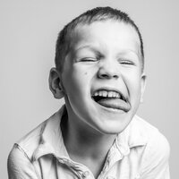 A young boy sticking his tongue out