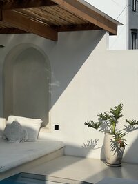 Ocean waves splashing against a wooden groyne, symbolizing stability, flow, and the natural rhythm of transformation in a coastal wellness setting.