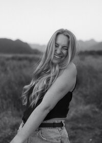 Rae Terrillon holding a camera, capturing authentic portrait moments across Vancouver Island and the Gulf Island