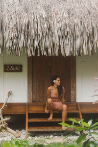 Woman on wooden steps during grounded travel experience
