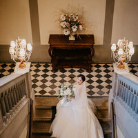 Chinese bride at the top of a staircase inside the magnificent Villa Pitiana.
