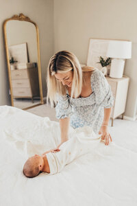 A mom swaddles her newborn baby in her home in La Mesa, California