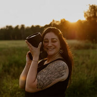 Photographer smiling for review of brand designer for photographers Palme Design Co