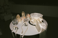 Dreamy Santorini Greece wedding reception, cake with satin ribbon, champagne toast