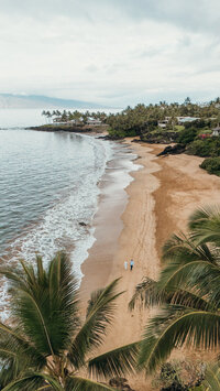 Maui Elopement Photographer captures couple holding hands in water