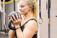 Woman holding a kettlebell for her brand session in Glasgow, Kentucky