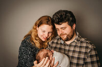 Mum & dad looking at newborn baby