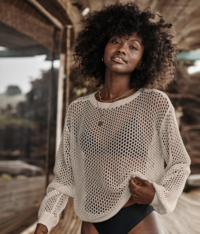 woman modeling a tan sweater