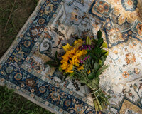yellow wedding bouquet laying on a rug