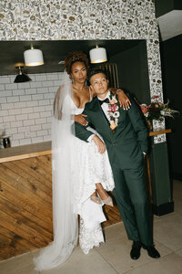 A bride wearing a lehenga and a groom in a suit in the sunlight at their wedding