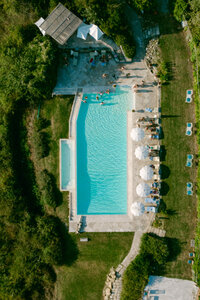 an ariel drone photo looking down at the wedding pool party at Laticastelli in Tuscany Italy