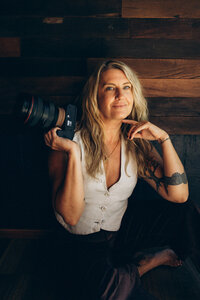Candid golden hour photo of Sunshine Coast photographer Nicci K walking with her camera.