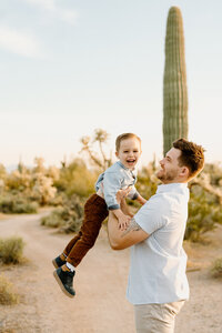 dad lifts son up