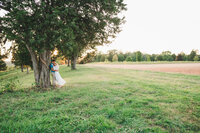 engaged couple snuggled together in a meadow in Dayton OH