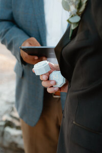 wedding ceremony photo of groom holding the box of wedding rings