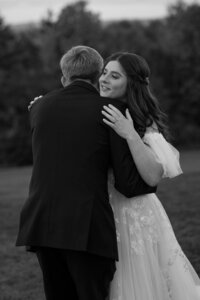 wedding couple hugging in black and white open field