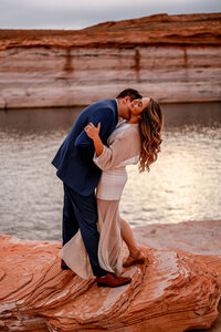 A quiet engagement proposal in a secluded cove of Lake Powell, with towering rock formations and calm waters surrounding the couple.