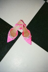 Editorial image of hot pink bridal heels on a black and white checkered dance floor captured on film photography 