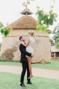 Light and airy cheshire wedding photographer taking a photo of a bride and groom 