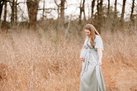 Pregnant mother looking at her baby bump at maternity session in San Antonio