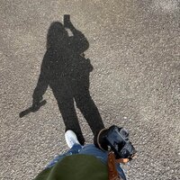 Danielle Rose Photography capturing a photo of her shadow while photographing an elopement at Cannon Beach, Oregon, highlighting her perspective as an elopement photographer in a breathtaking coastal setting.