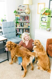 woman sitting in her home office with her two dogs