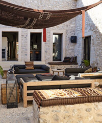 Luxury terrace and patio dining setup overlooking the sea in a Mediterranean villa.