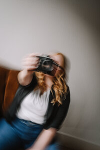 Women holding camera out with a artistic editing style.
