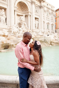 Photo of a couple embracing and staring into each others eyes in front of the Trevi Fountain. Taken by Rome Photographer, Tricia Anne Photography.