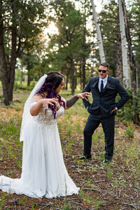 Bride playfully jumping on the groom’s back during a candid and fun Woodland Park Colorado elopement.