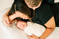 newborn baby girl held by parents  by Springfield MO newborn photographer The XO Photography