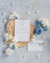 Wedding invitation flatylay on a blue background