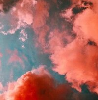 Bright teal, orange, and pink sunset with clouds