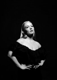 Black-and-white image of woman in studio lighting, confidently posing – professional posing support provided in The Studio Lab sessions