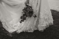 bridal bouquet, bride holding bouquet against wedding dress