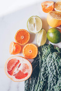 Citrus halves and kale leaves