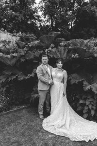 BRIDE AND GROOM POSE IN THE GARDENS OF HATCH HOUSE DURING THEIR PORTRAIT SESSION AT THEIR WEDDING