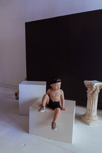 Baby in front of black backdrop in modern photography studio in Troy, Missouri