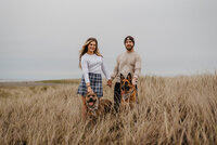 couple with dogs in field