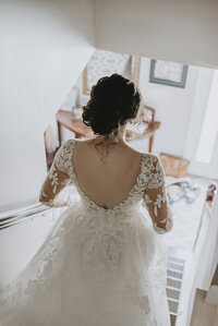 fallback shared on Invalid Date | a bride walking down stairs in her dress