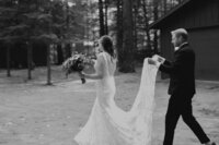 Couple walking in backyard during wedding portraits